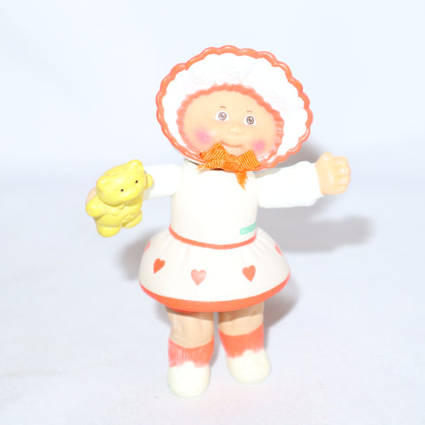 Cabbage Patch Kids Kid Holding a Yellow Teddy Bear