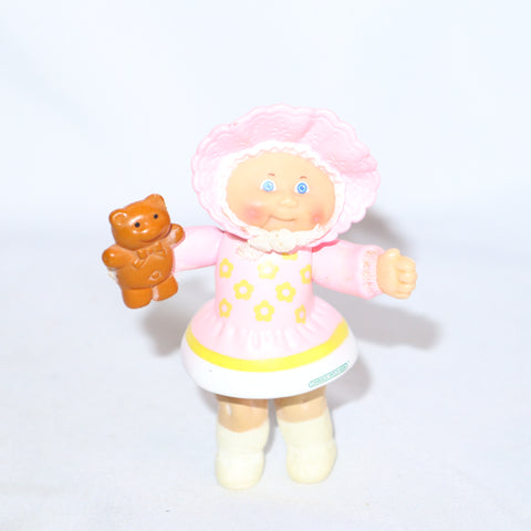 Cabbage Patch Kids Kid Holding a Brown Teddy Bear